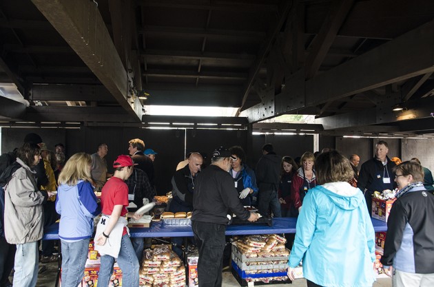 People line up for grilled salmon, hot dogs, chips and drinks.