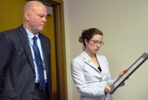 Ferry chief Mike Neussl listens as legislative aide Cecile Elliott reads a legislative proclamation commending the Alaska Marine Highway System in 2012. (Ed Schoenfeld/CoastAlaska News)