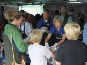 Gov. Sean Parnell and First Lady Sandy Parnell dish out food. (Photo by Lisa Phu/KTOO)