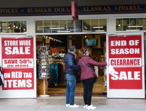 Tourists consider checking out a sale on South Franklin Street, Juneau's gift-shop row, next to cruise ship docks, on one of the last days of 2014's tourism season. (Ed Schoenfeld, CoastAlaska News)