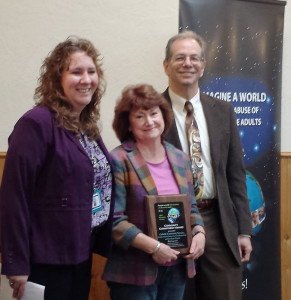 Tonya Muldoon (left), state Adult Protective Services, and Jon Sherwood (far right), Alaska Division of Senior and Disabilities Services, congratulate Marianne Mills, who accepted the 2014 Adult Protective Services Southeast Community Commitment Award on behalf of Southeast Senior Services Sept. 19. (Photo courtesy of Department of Health and Social Services)