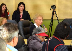 Tlingit elder Kaséix̱ Selina Everson speaks after Gov. Sean Parnell signed a bill making Alaska's Native languages official languages of the state of Alaska. Former Tlingit Haida Central Council President Ed Thomas and Lance Twitchell look on in the foreground. (Photo by Jennifer Canfield/KTOO)