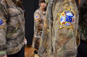 Tanana 4-H members wore Alaska State Trooper patches on their kuspuks in honor of two troopers who were killed by a Tanana man in May. (Photo by Jennifer Canfield/KTOO)
