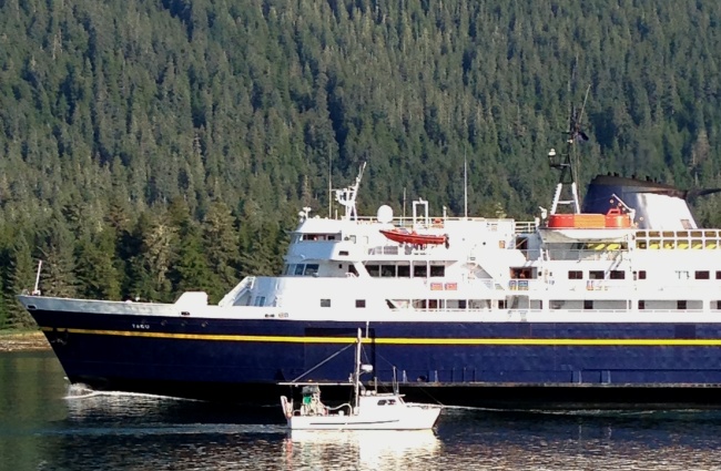 A Petersburg fishing boat passes the ferry Taku near the entrance of Wrangell Narrows in August, 2013. (Ed Schoenfeld/CoastAlaska News)