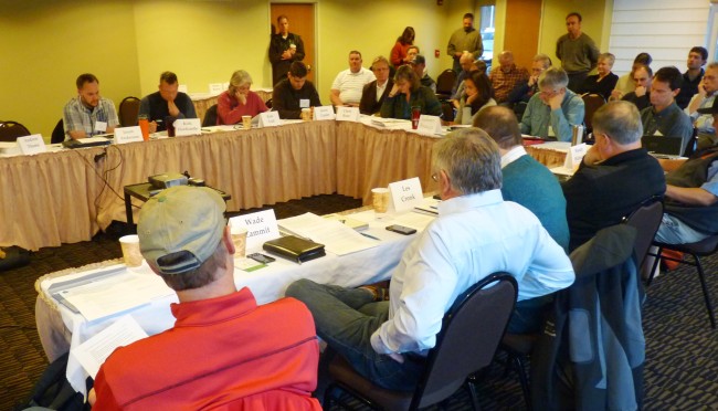Tongass Advisory Committee members discuss timber transition issues while audience members watch during a Jan. 20 meeting at Juneau's Aspen Hotel. (Ed Schoenfeld/CoastAlaska News)