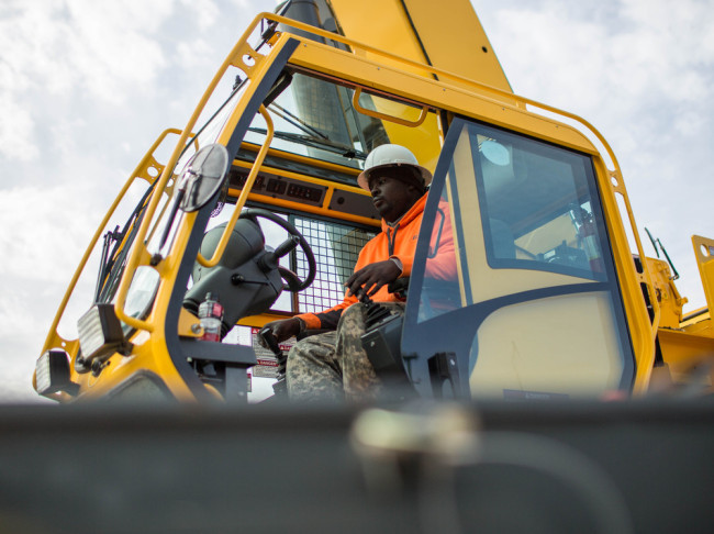 Former student Nathaniel Simmons operates a crane during a day of training at Georgia College of Construction. The Department of Labor says construction was one of several sectors that showed job gains in December. Branden Camp/AP