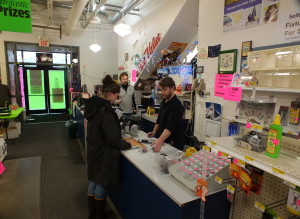 Sales clerks help a customer at Good Hardware. (Photo by Matt Miller/KTOO)