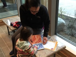 Margaret Katzeek brought her niece Elayna Katzeek to the Baby Raven Reads family night. (Photo by Lisa Phu/KTOO)