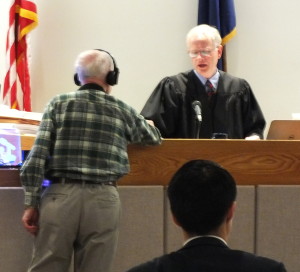 Defendant Ray Coxe hands Juneau Superior Court Judge Philip Pallenberg a note following closing arguments in the civil trial. (Photo by Matt Miller/KTOO)