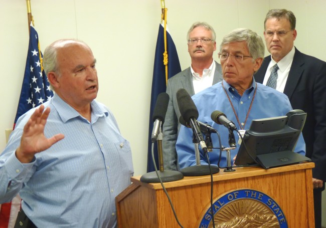 B.C. Mines Minister Bill Bennett discusses the week's mine meetings as Lt. Gov. Byron Mallott and other state officials listen during a Wednesday press conference. (Photo by Ed Schoenfeld/CoastAlaska News).