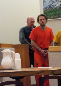 Christopher D. Strawn is escorted into the courtroom on Thursday to face a charge of first degree murder. (Photo by Matt Miller/KTOO)