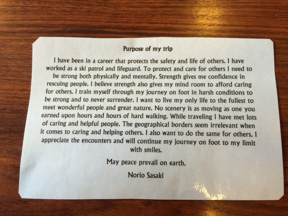 When asked why Sasaki is walking around the world he handed us this. (Photo by Scott Burton/KTOO)