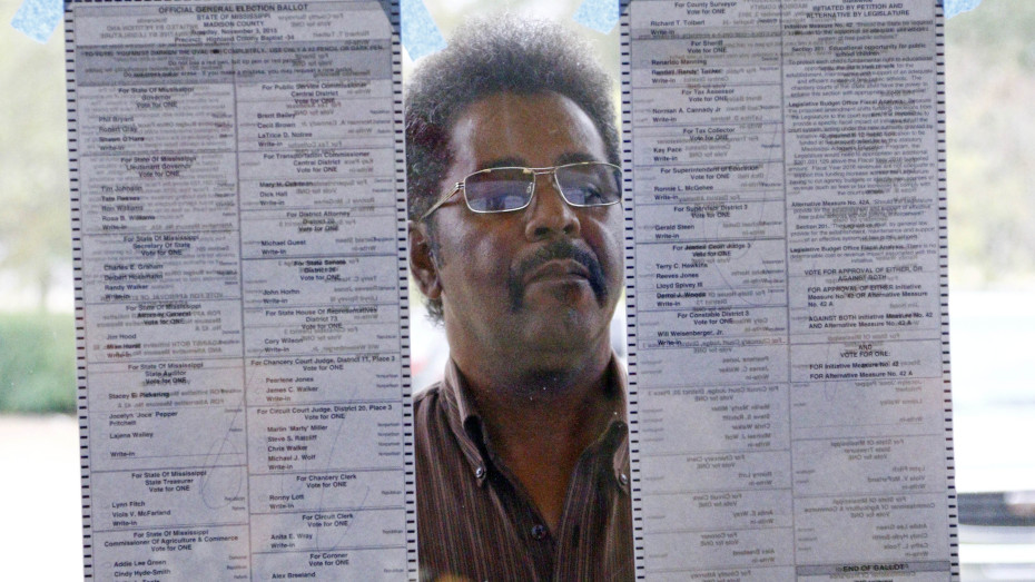 Bobby McMurtry reviews the list of candidates outside his precinct prior to voting in Ridgeland, Miss. (Photo by Rogelio V. Solis/AP)