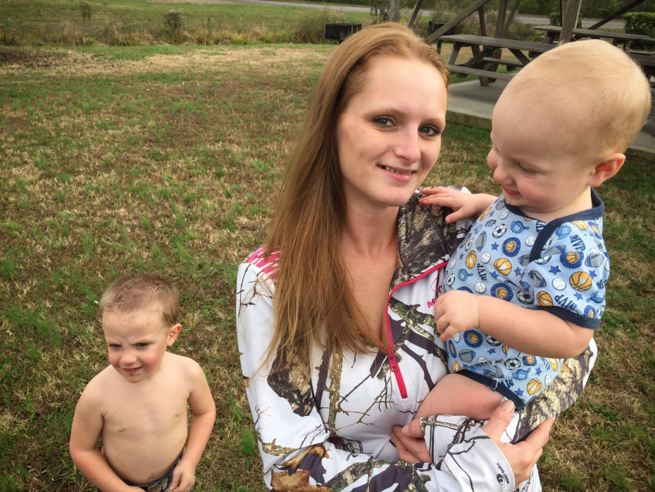 Brittany Crowe just completed an addiction treatment program that helped her regain custody of her children. Here she holds Allan, who was born with neonatal abstinence syndrome, as her son James stands behind them. Ari Shapiro/NPR